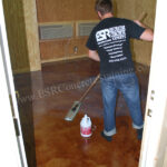 Applying a protective coating of wax to this decorative concrete floor